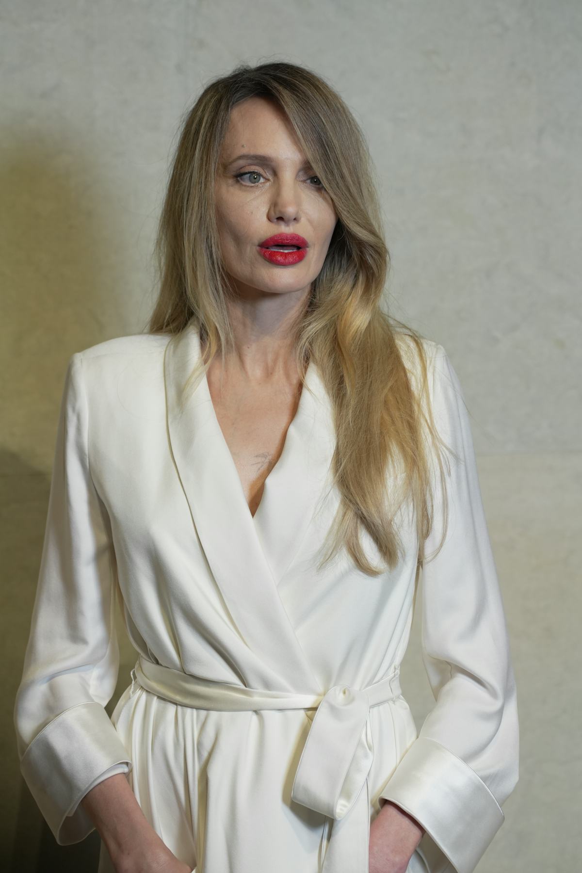 Angelina Jolie Styles Robe Coat With Bold Red Lip and Side Part Hair