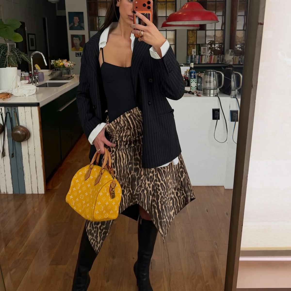 Dua Lipa Boosts High-Contrast Prints With A High-Voltage Speedy Bag